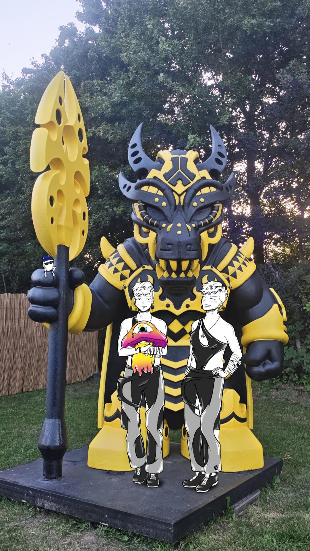 Defqon.1 2026 – 2 VISIV characters posing in front of a yellow festival statue at Defqon.1 2026.