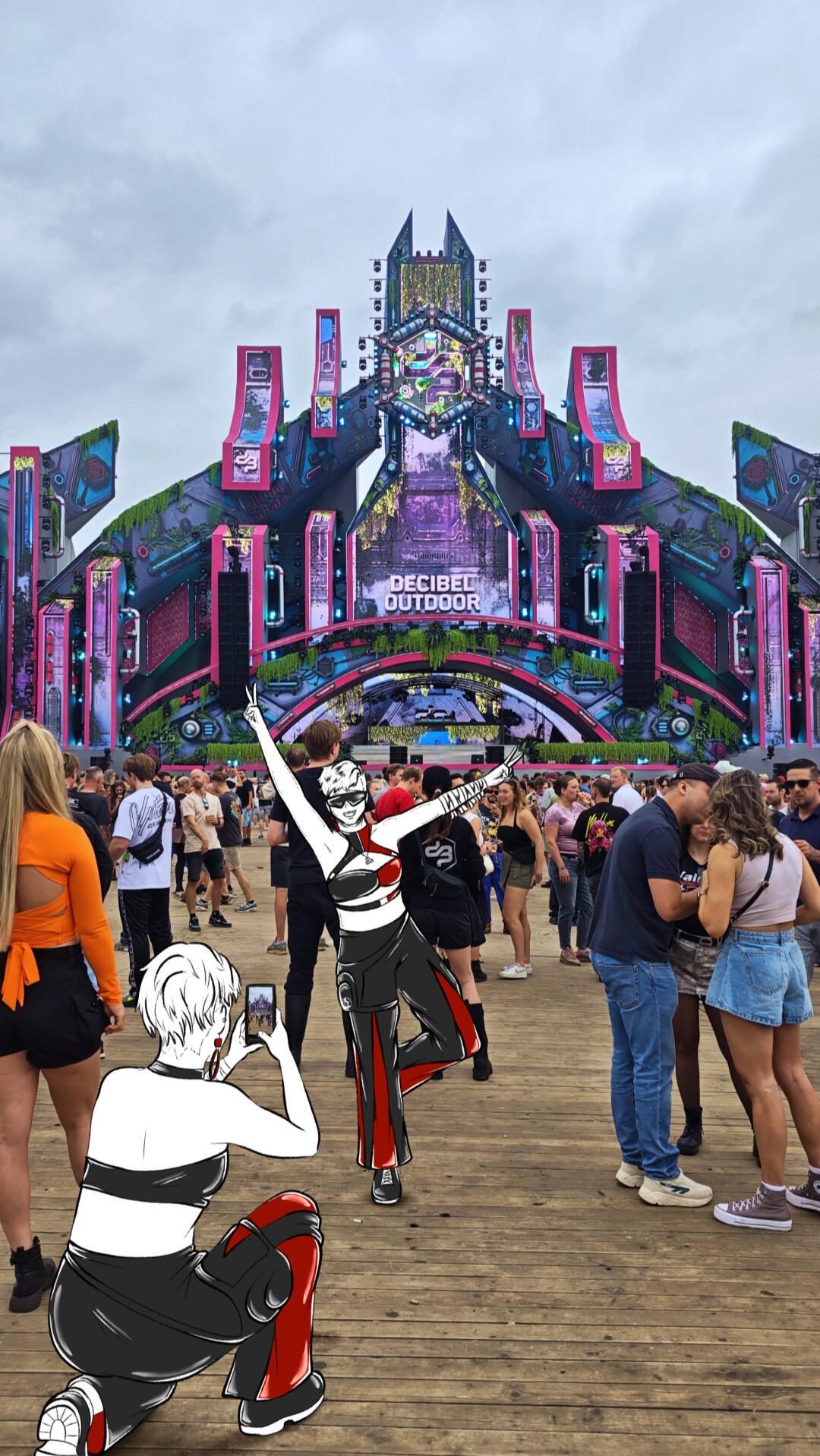 One VISIV character photographing the other in front of the Decibel Outdoor 2026 mainstage.